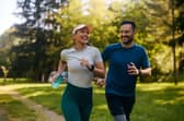 Happy athletic couple having fun while running together.
