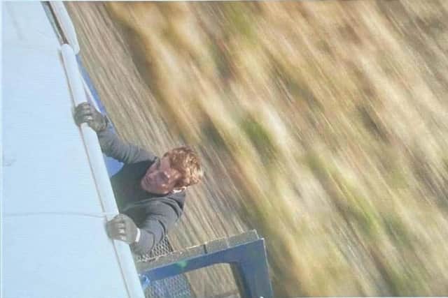 The image director Christopher McQuarrie shared on Instagram shows Cruise dangling from the side of a train (Photo: Instagram/@christophermcquarrie)
