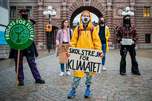 Swedish climate activist Greta Thunberg protests with demonstrators during a "Fridays for Future" protest in front of the Swedish Parliament Riksdagen in Stockholm on October 9, 2020.
