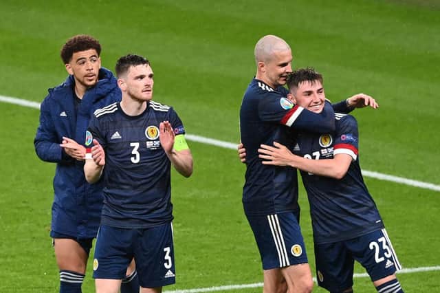 Scotland's forward Che Adams, defender Andrew Robertson, and striker Lyndon Dykes with midfielder Billy Gilmour after the Group D match between England and Scotland at Wembley Stadium.