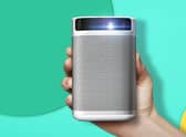 The XGIMI MoGo Pro 1080p portable projector is a compact, neat, curved-edge unit of white and silver. Image XGIMI