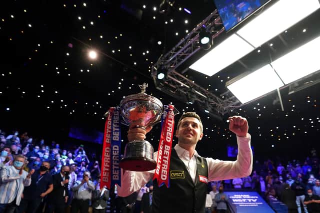 Selby parades his trophy after winning the the world title for the fourth time. Only Steve Davis and Ronnie O'Sullivan (6) and Stephen Hendry (7) have won it more.