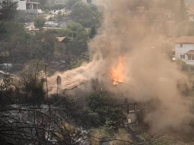 A house burning during a wildfire in Avanta, near Alexandroupoli, northern Greece. Wildfires have hit the region over the past few days.