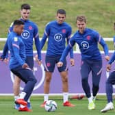 England's striker Patrick Bamford (C) and team-mates attend an England training session at St George's Park.
