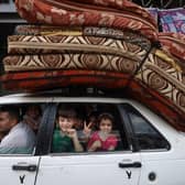 A Palestinian family returns to their house in Gaza City after a ceasefire was agreed between Israel and Hamas. (Pic: Getty)