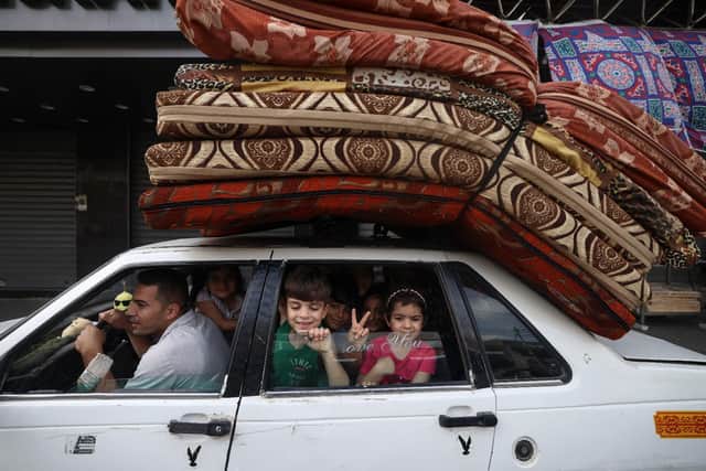 A Palestinian family returns to their house in Gaza City after a ceasefire was agreed between Israel and Hamas. (Pic: Getty)