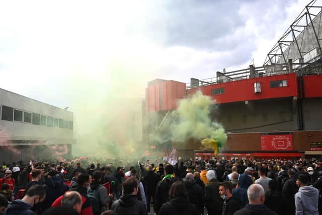 Fans are seen protesting against Manchester United's Glazer ownership outside the stadium prior to the Premier League match between Manchester United and Liverpool at Old Trafford.