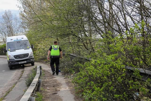 Police at the scene after human remains were discovered in woodland next to the M6 in the Black Country (Photo: SWNS)