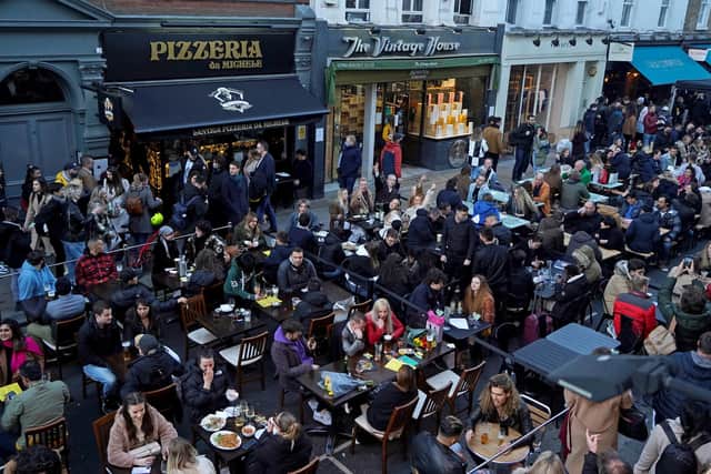 Diners eat in the streets of Soho on April 16 following step two of the government's roadmap out of England's lockdown (Niklas Halle'n/AFP via Getty)