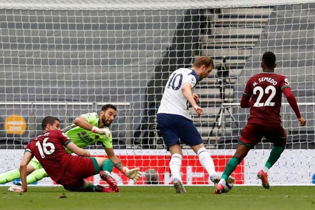 Harry Kane shoots past Wolverhampton Wanderers' Portuguese goalkeeper Rui Patricio (2nd L) to score the opening goal in their Premier League win.