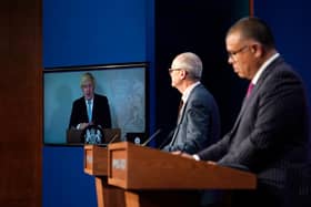 Chief ccientific advisor Patrick Vallance (L) and deputy chief medical officer professor Jonathan Van Tam (R) at Downing Street with Boris Johnson attending online via a screen from Chequers where he is self-isolating (WPA Pool/Getty)