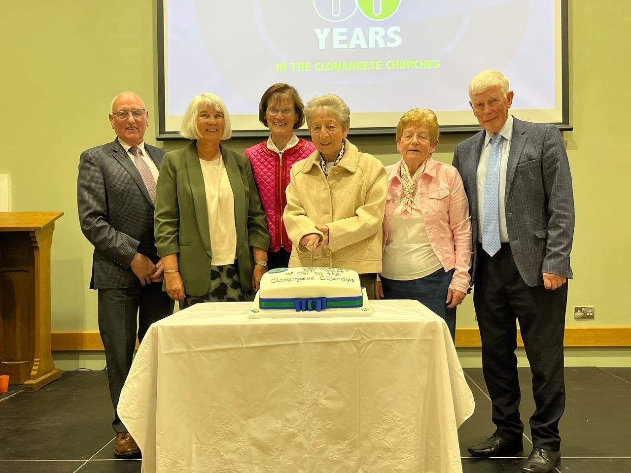 Founder members gathered around Mrs Hazel Williamson for the cake-cutting ceremony.