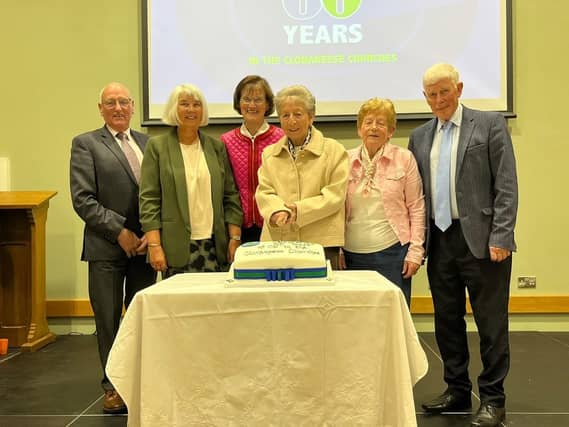 Founder members gathered around Mrs Hazel Williamson for the cake-cutting ceremony.