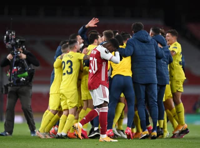 Eddie Nketiah of Arsenal looks dejected as the Villareal CF team celebrate victory following the UEFA Europa League semi-final second leg match