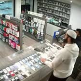 A bungling thief was left red-faced after he tried to make off with £1,600 worth of mobile phones but couldn't escape the store - because the door locked behind him.