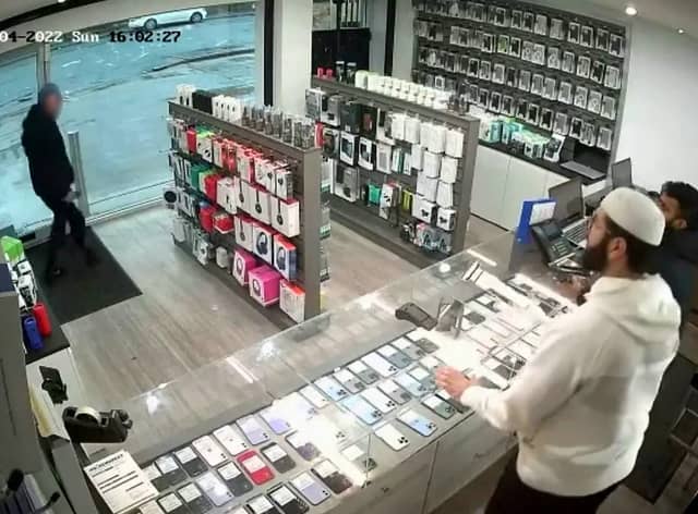 A bungling thief was left red-faced after he tried to make off with £1,600 worth of mobile phones but couldn't escape the store - because the door locked behind him.
