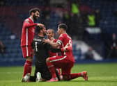 Alisson Becker of Liverpool is congratulated on scoring the winning goal by Mohamed Salah, Thiago Alcantara and Roberto Firmino during the Premier League match between West Bromwich Albion and Liverpool at The Hawthorns.