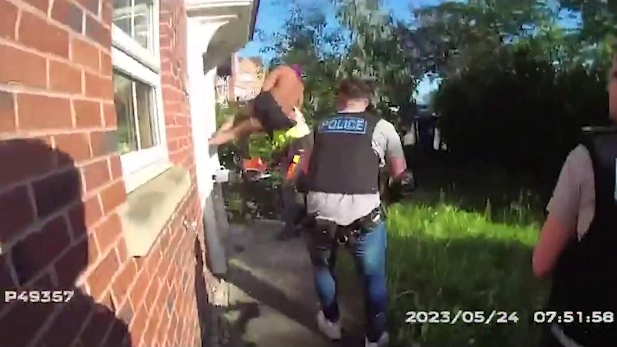 Watch daring moment drug dealer jumps on police officer using a chainsaw in desperate escape attempt