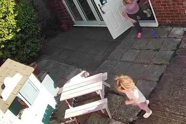These cheeky toddler twins have been filmed outwitting their NHS scientist mum to avoid ending playtime - by running away every time she carries the other inside.