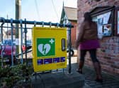 Life saving defibrillators can be clearly identified in their prominent green cabinet and green overhanging sign (Getty Images)