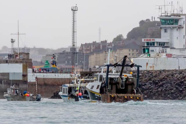 French fishing boats sail into the harbour in protest against the new fishing licences on May 6, 2021 in St Helier, Jersey.