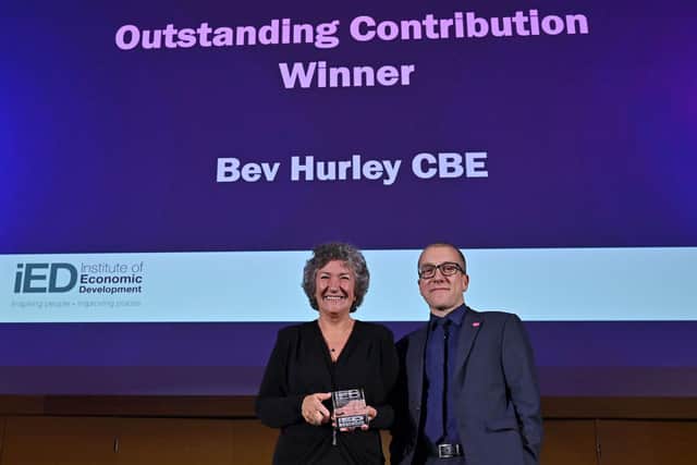 Bev receiving her award from IED Chair Tom Stannard.