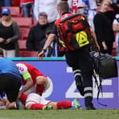 Denmark's midfielder Christian Eriksen receives medical attention after collapsing on the pitch during the UEFA EURO 2020 Group B football match between Denmark and Finland.