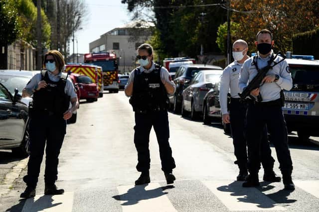 French police officials block off a street near a police station in Rambouillet, south-west of Paris, on April 23, 2021, after a woman was stabbed to death in the town (Photo by BERTRAND GUAY/AFP via Getty Images)