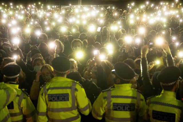 People turn on their phone torches as they gather in Clapham Common for a vigil for Sarah Everard on 13 March 2021 (Photo: Victoria Jones/PA Wire/PA Images)