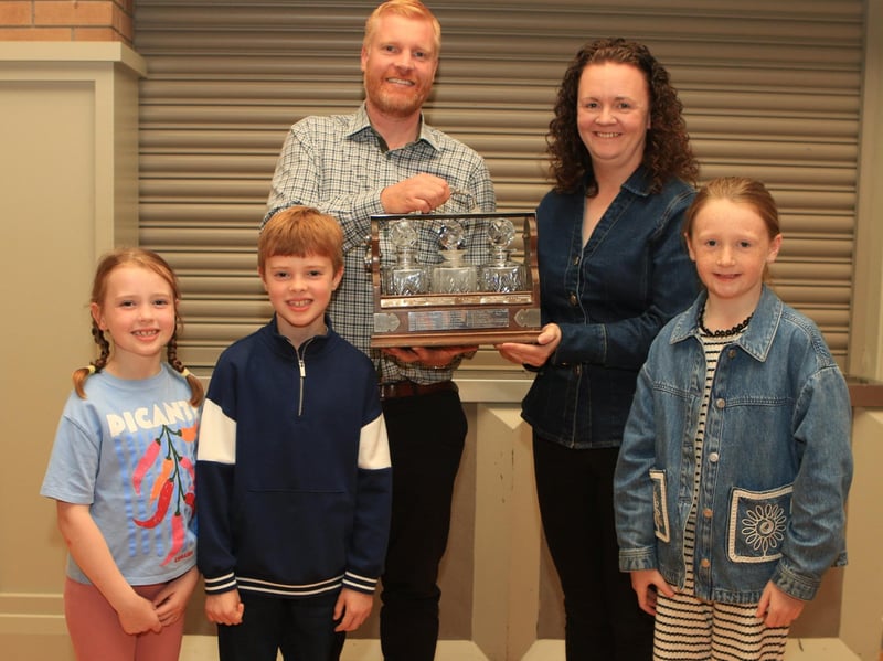 Christopher Weatherup and kids Rita and Archie pictured with Geraldine McElduff, Countryside Services, along with her daughter Molly presenting the Bobbie Gamble Perpetual Challenge Trophy for the Best Simmental Female born on or after 1st January 2023 – 30th June 2024 at Balmoral show for Lisglass Sapphire.