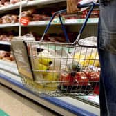 A person holding a shopping basket in a supermarket. PIC: Julien Behal/PA Wire
