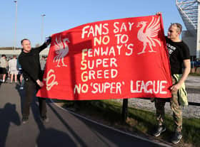 Fans hold up a protest banner against Liverpool FC and the European Super League outside the stadium prior to the Premier League match between Leeds United and Liverpool.