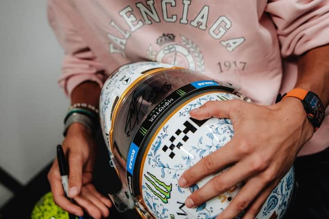 Lando Norris signing his 2024 Hungarian Qualifying Helmet