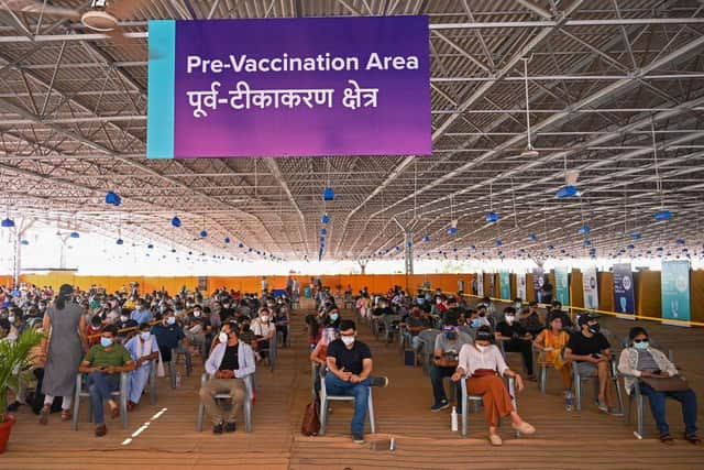 People wait to get a dose of the Covishield vaccine against the Covid-19 coronavirus at the vaccination center of BLK-Max hospital in New Delhi. India continues to struggle against coronavirus.