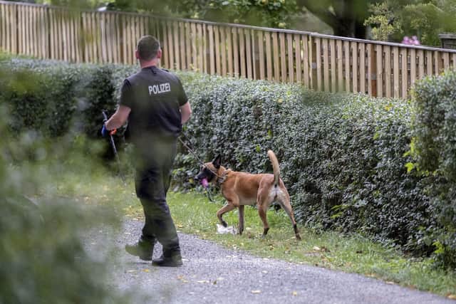Picture shows German police officers searching an allotment garden plot in Seelze, near Hannover, Germany, Tuesday July 28, 2020. Police have begun searching an allotment garden plot, believed to be in connection with the 2007 Portugal disappearance of missing British girl Madeleine McCann. (Peter Steffen/dpa via AP)