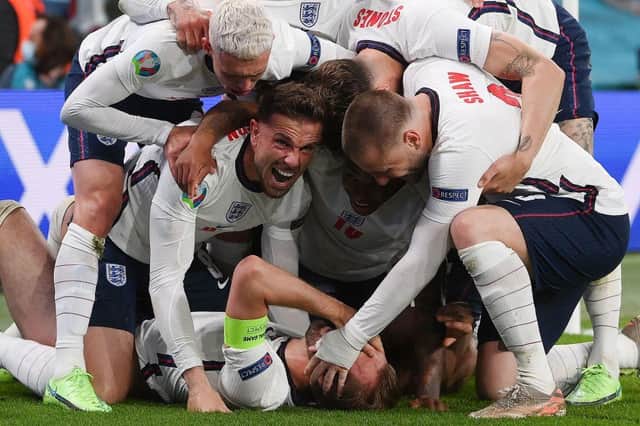 England's forward Harry Kane (bottom) celebrates with teammates after scoring a goal during the UEFA EURO 2020 semi-final football match between England and Denmark at Wembley Stadium in London on July 7, 2021. (Photo by Laurence Griffiths / POOL / AFP) (Photo by LAURENCE GRIFFITHS/POOL/AFP via Getty Images)