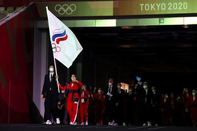 Flag bearers Sofya Velikaya and Maxim Mikhaylov of Team ROC lead their team out during the Opening Ceremony of the Tokyo 2020 Olympic Games (Photo: Jamie Squire/Getty Images)