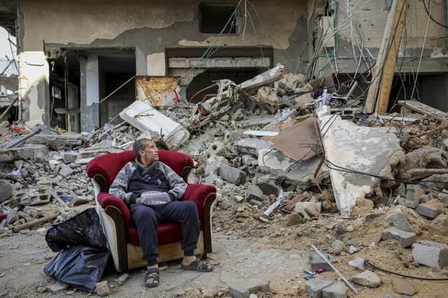 A Palestinian man sits in an armchair outside a destroyed building in Gaza City on Wednesday. (AP Photo/Mohammed Hajjar)