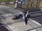A worrying image of a girl using her phone on live train tracks has been released to warn children about the dangers (Network Rail)