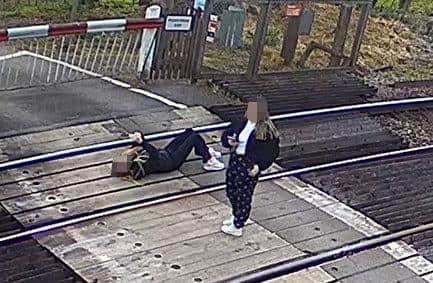 A worrying image of a girl using her phone on live train tracks has been released to warn children about the dangers (Network Rail)