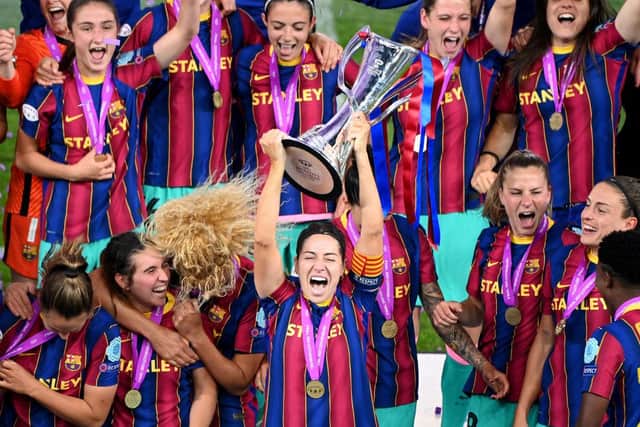 Vicky Losada of FC Barcelona lifts the UEFA Women's Champions League Trophy in celebration with team mates following the win over Chelsea.