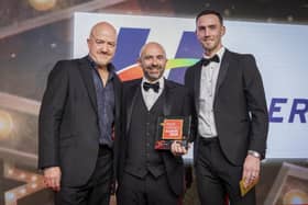 Michael Surginor from Henderson Retail picks up the award for Forecourt Retailer of the Year at the Retail Industry Awards 2025 in London
