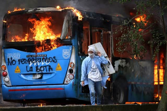 A public transportation bus in flames during a protest against the tax reform bill launched by Colombian President Ivan Duque (Photo: PAOLA MAFLA/AFP via Getty Images)