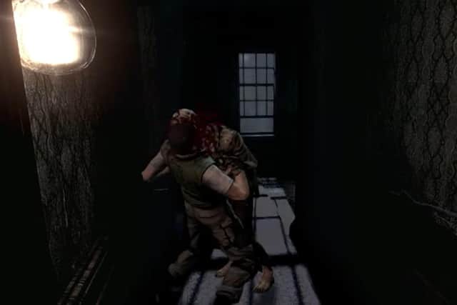 Chris Redfield is attacked by a zombie in Resident Evil (2002)
