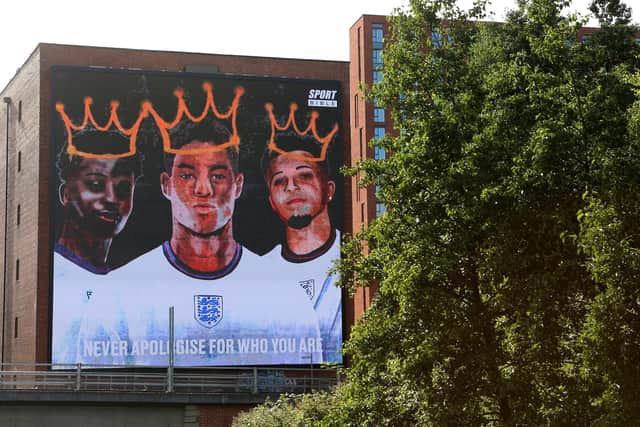 A giant mural in support of three England footballers Marcus Rashford, Jadon Sancho and Bukayo Saka has been unveiled in Manchester after the England stars were targeted with racist abuse online (Getty)
