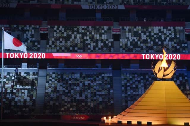 Empty seats are seen as the Olympic Flame burns after the lighting of the Olympic Cauldron during the opening ceremony of the Tokyo 2020 Olympic Games (Photo: FRANCK FIFE/AFP via Getty Images)