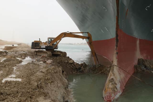A digger is attempting to free the Ever Given, a giant cargo ship which ran aground on 23 March in the Suez Canal, Egypt (Photo: Suez Canal Authority)