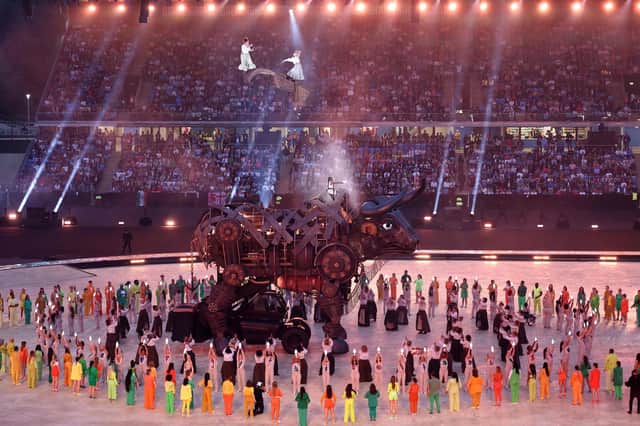 <p>Performers remove the headpiece of The 'Raging Bull' during the opening ceremony</p>