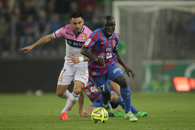 Evian's French midfielder Adrien Thomasson (L) vies for the ball with Caen's French midfielder N'golo Kante (R) during the French L1 football match between Caen (SM Caen) and Evian (ETG), on May 23, 2015, at the Michel d'Ornano stadium, in Caen, northwestern France. CHARLY TRIBALLEAU/AFP via Getty Images