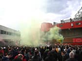 Fans are seen protesting Manchester United's Glazer ownership outside the stadium prior to the Premier League match between Manchester United and Liverpool at Old Trafford. The game was eventually postponed.